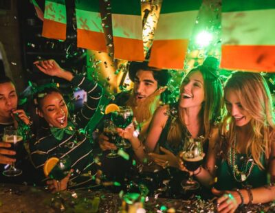 Happy multi-ethnic friends drinking and having fun at Saint Patrick's day night club party