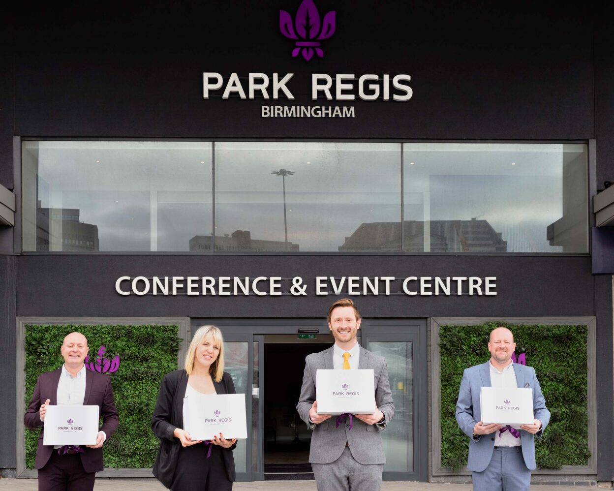 Four Park Regis Birmingham staff holding certificates