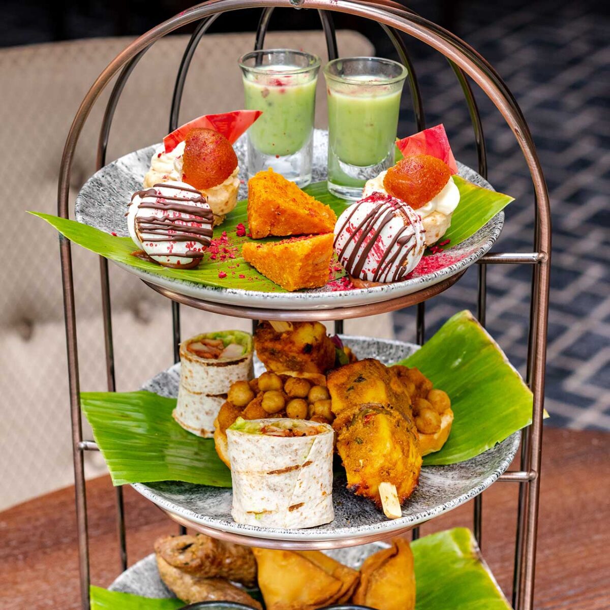 An afternoon tea platter of Indian sweets and savouries