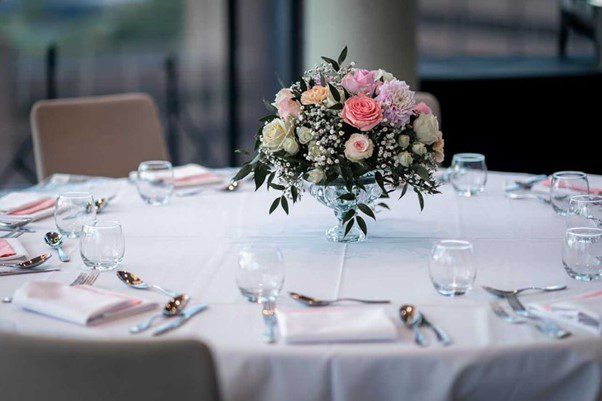 Glasses, Spoons and Fork on the Dining Table with a Flowerpot