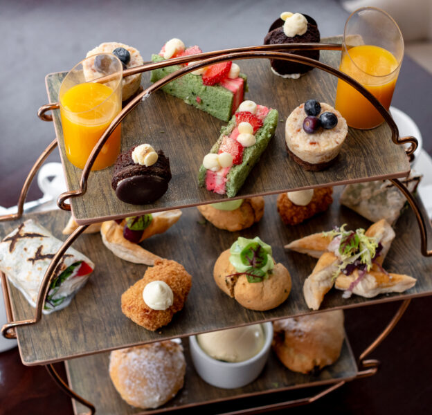 three-tier afternoon tea with scones, savoury pastries and mini cakes