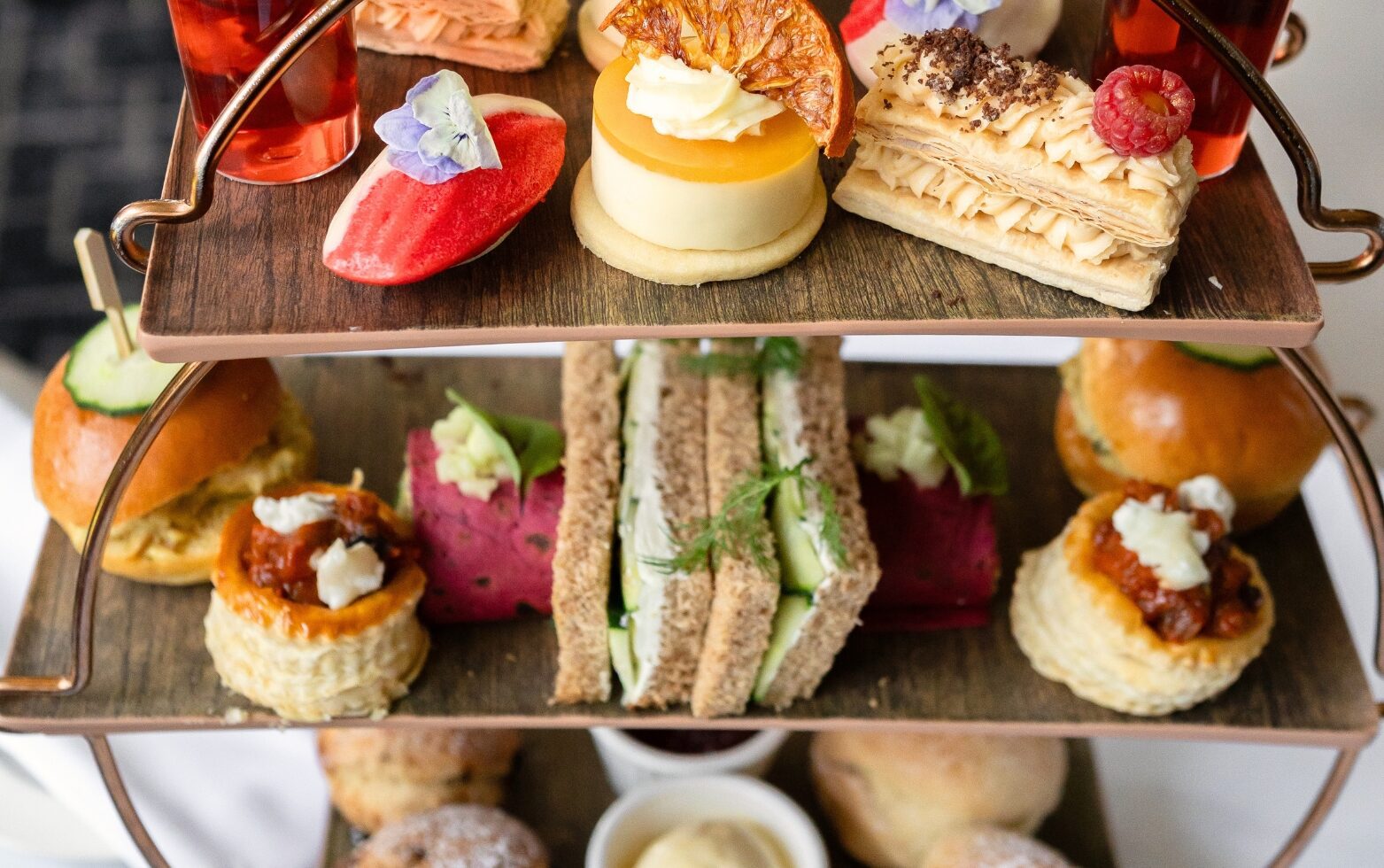 luxury afternoon tea at Park Regis Birmingham, featuring finger sandwiches, mini cheesecakes, scones and more sweet and savoury delicacies.